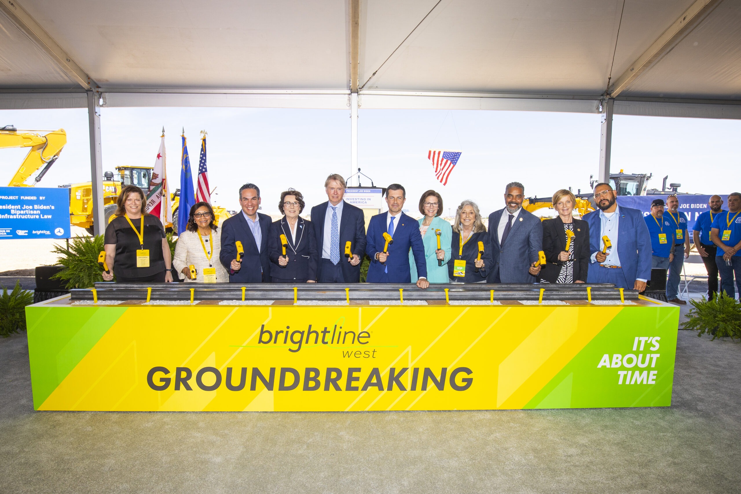 people posing for image behind yellow sign