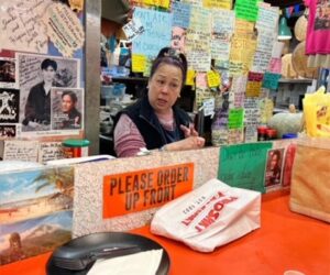 leila rosas standing and talking in her store, Oriental Mart, 