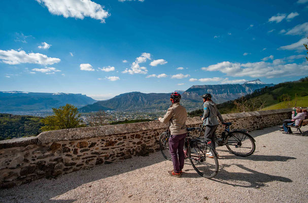 two people standing next to their bikes in grenoble alpes in france