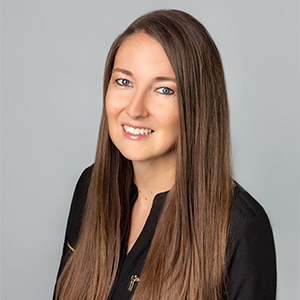 woman smiling, wearing black long sleeve shirt