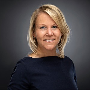 woman smiling, wearing dark blue shirt