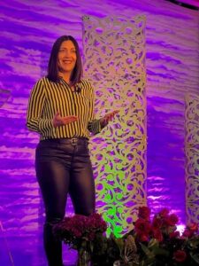 woman speaking on a stage