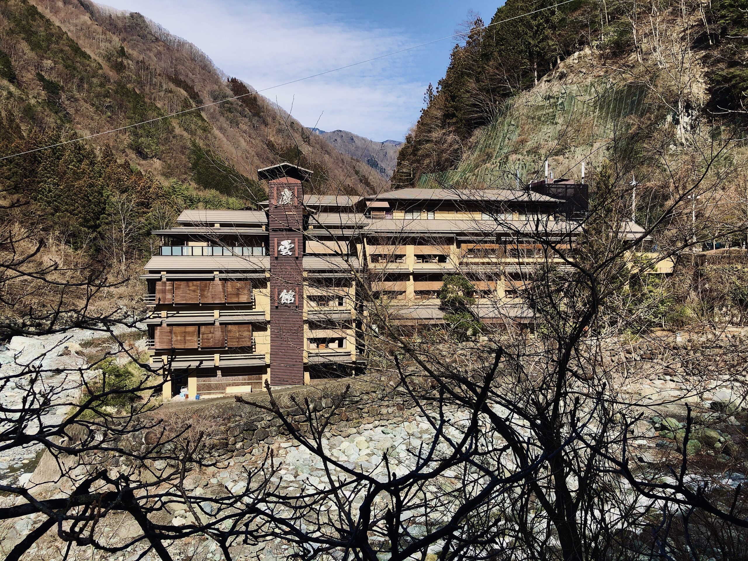 wide shot of hotel in among trees