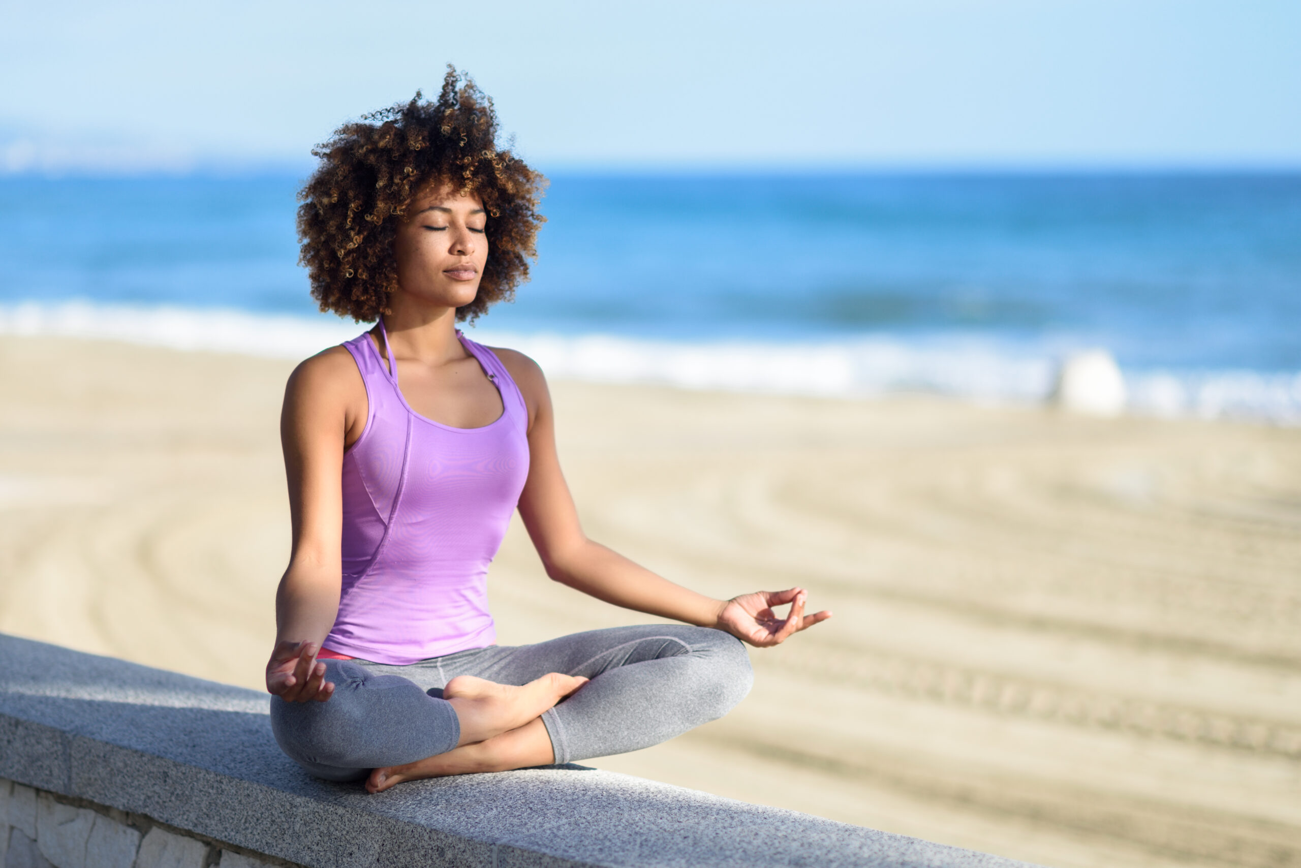 woman near beach doing yoga