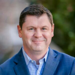 man wearing blue dress shirt and sport coat