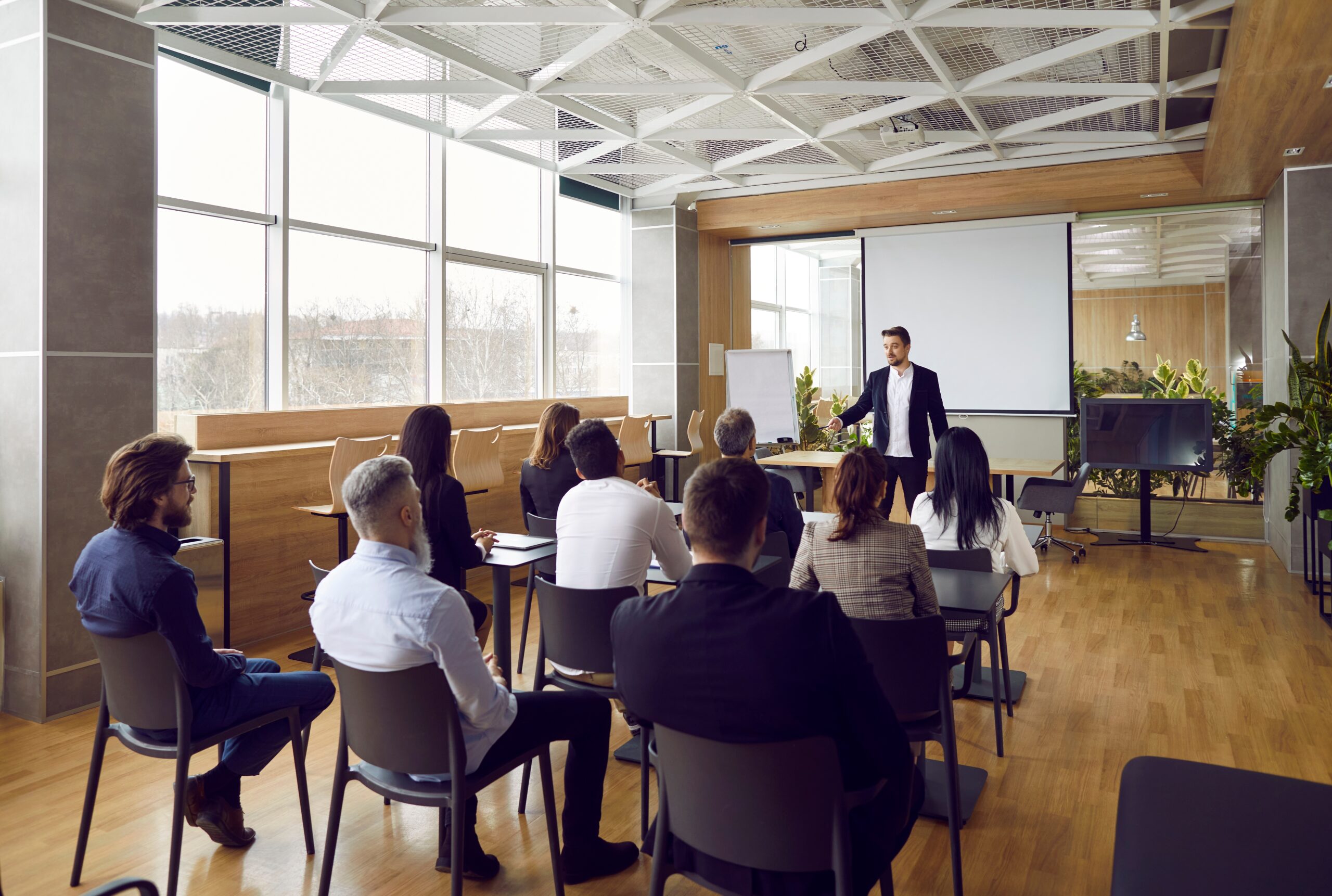 man talking to room full of people