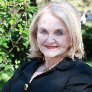 woman smiling in front of green background