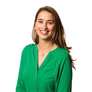 woman in bright green long sleeve shirt smiling