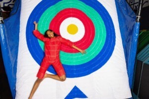 woman stuck to Velcro wall