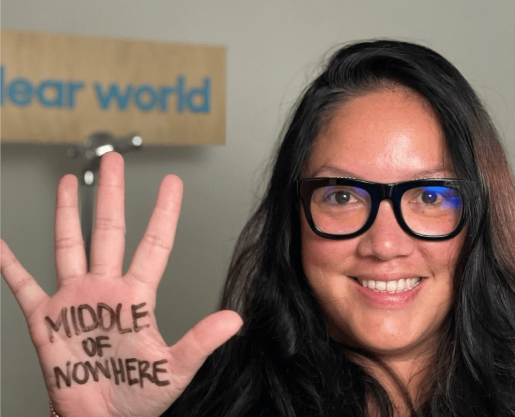 Mariana Miranda holding hand open with words "Middle of Nowhere" in her palm