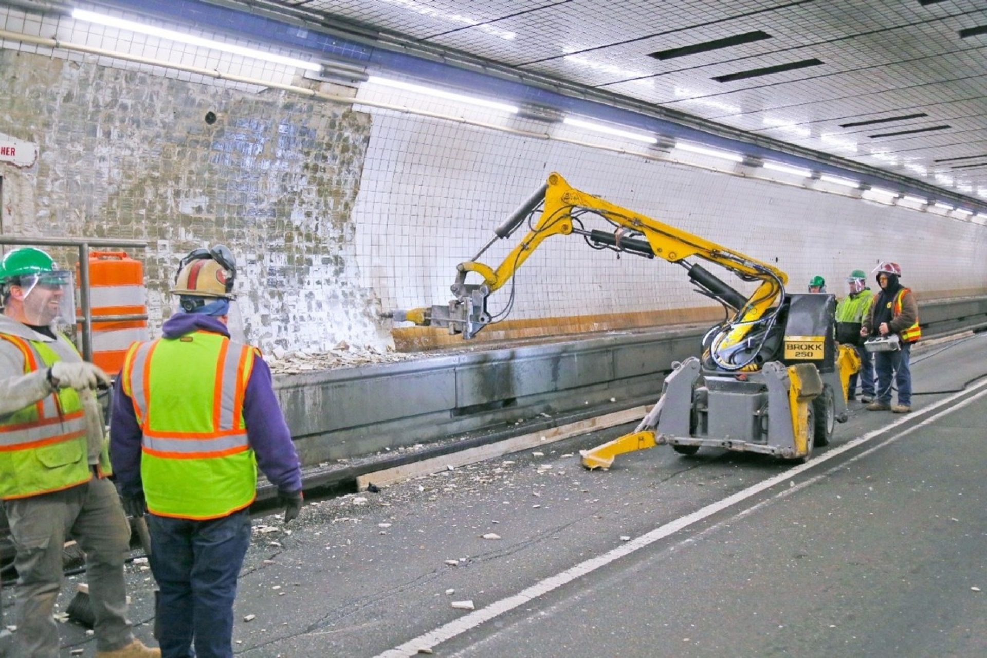 construction workers operating machine