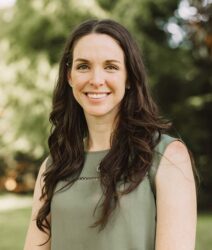 Dominique Dewitt wearing sleeveless green shirt