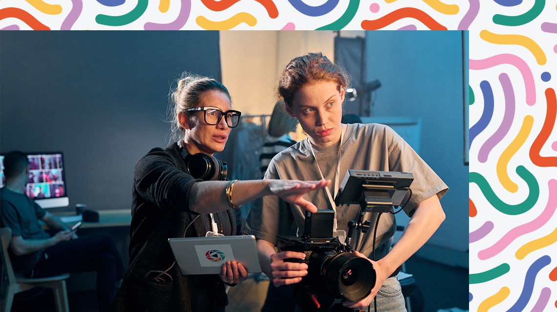 two women working on camera